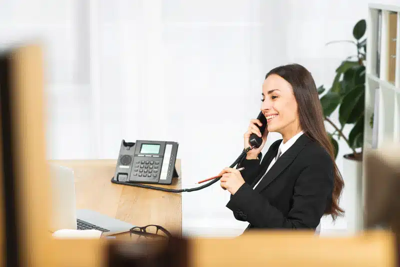 Woman answering hotline calls at her desk