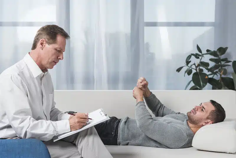 Man talking during therapy at treatment center