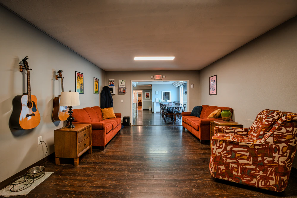 room-with-couches-and-guitars-on-the-wall